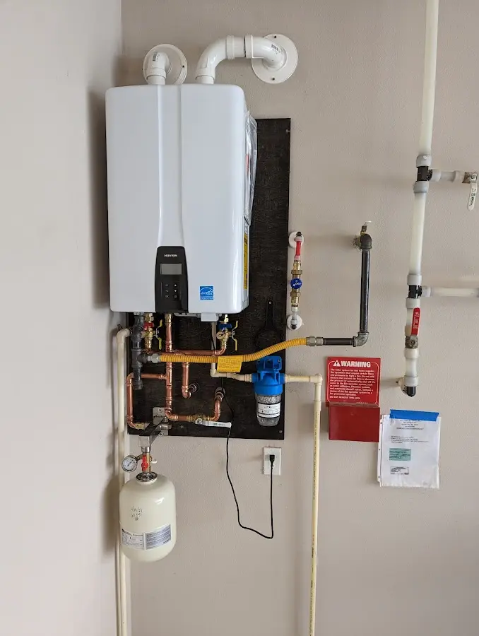 Professional plumber installing copper piping in a Upper Makefield home